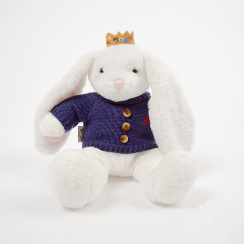White plush bunny toy wearing a purple sweater with buttons on a white background