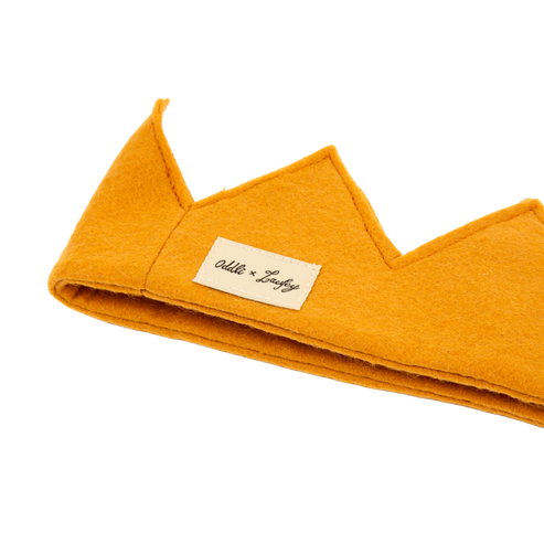 Mustard yellow pet bed with a brand label on a white background