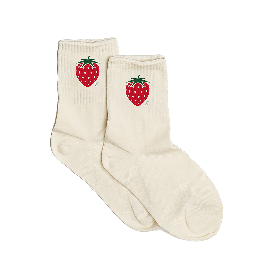 Pair of cream socks with strawberry design on a white background