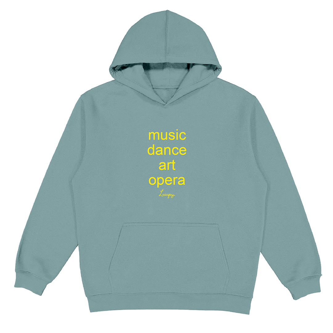 A dusty blue-gray pullover hoodie with yellow text on the chest reading 'music dance art opera' and a small signature-style 'Lore' underneath, shown on a plain white background.