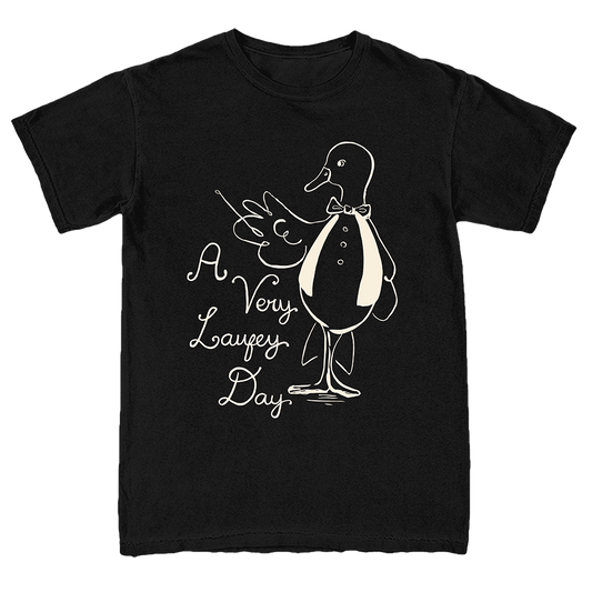 A black short-sleeve crewneck t-shirt featuring a white line art graphic of a duck in a tuxedo next to the text 'A Very Lafezy Day' in a cursive font.