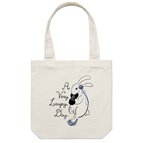 An off-white canvas tote bag with two handles, featuring a black and blue line art illustration of a rabbit holding a guitar next to the text 'A Very Lafezy Day' on a plain white background.
