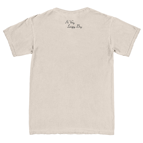 A light beige crewneck t-shirt shown from the back, featuring the text 'A Very Long Day' printed in a small black cursive font near the upper center back.