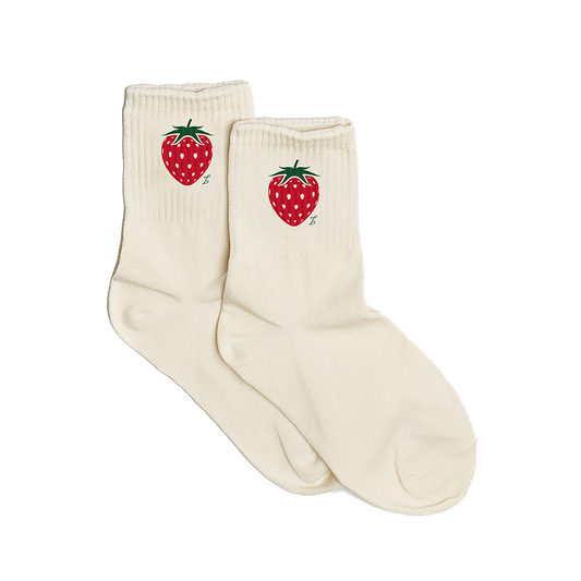 Pair of cream socks with strawberry design on a white background