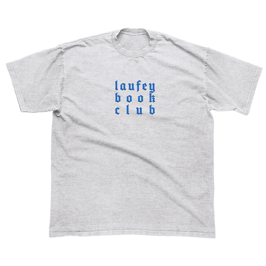A light heather gray short-sleeve t-shirt with the words 'laufey book club' printed in blue gothic-style lettering on the chest, displayed flat against a white background.